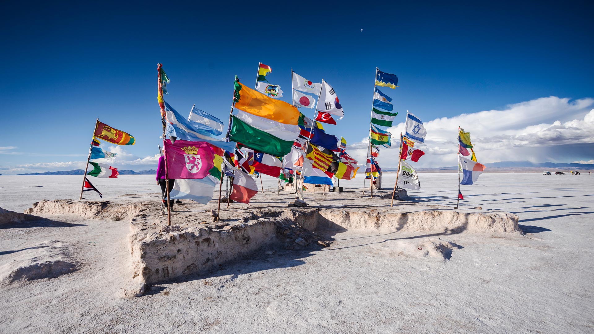 Many different country flags in a salt desert in Salar de Uyuni, Bolivia